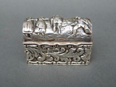 A George V miniature hallmarked silver casket with gilt wash interior and embossed decoration,