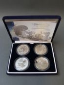 A cased set of four silver Britannia coins 1999, 2001, 2002,