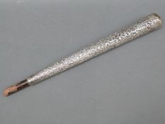 A white metal Indian walking stick or parasol handle with floral decoration,