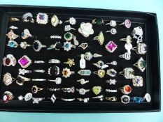 Over 50 silver/white metal rings, some set with cubic zirconia,