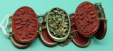 A Chinese cinnabar lacquer bracelet with white metal fittings