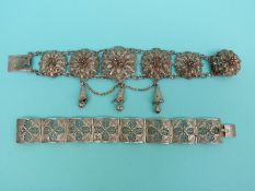 A white metal filigree bracelet made up of six layered flowers and a white metal filigree bracelet