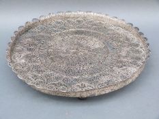 A continental white metal filigree tray raised on filigree ball feet,