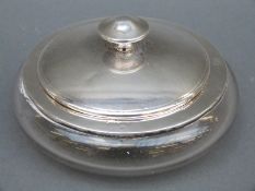 A hallmarked silver and cut glass powder bowl with mirror lid,