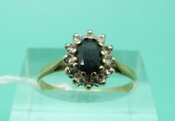 A 9ct gold ring set with a sapphire surrounded by diamonds (Size M)