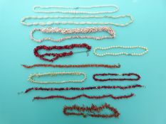 Six coral necklaces including examples made up of irregular pieces, a shell necklace,