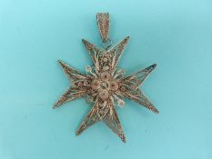 A white metal filigree pendant in the form of a Maltese cross