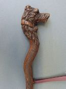 A Victorian carved ladies walking stick with dog's head finial and opening mouth,