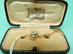 A Victorian brooch in the form of an insect set with seed pearls and a turquoise cabochon in