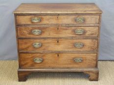 A George III mahogany chest of four straight graduated drawers, raised on bracket feet,
