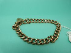 A 9ct gold curb link bracelet with padlock clasp, weight 37.