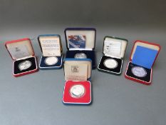 Six various silver crowns, cased with certificates to include Britannia Royal Commemoratives,