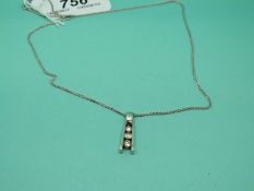 An 18ct gold necklace/ chain and an 18ct white gold pendant set with three graduating diamonds
