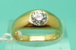 A yellow metal ring set with an old cut solitaire diamond of approximately 0.