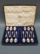 A Harrods cased set of 12 hallmarked silver teaspoons and tongs,