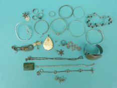 A silver bangle set with a diamond, silver bracelets, white metal hoop earrings,