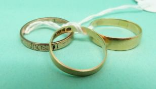 Two 18ct gold wedding rings (weight 4.6g) and a yellow metal wedding ring (2.