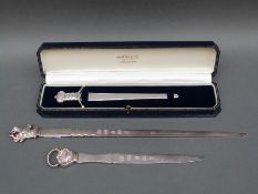 Three hallmarked silver letter openers two with feature hallmarks,
