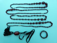 Four cherry amber necklaces and a large barrel shaped piece of amber