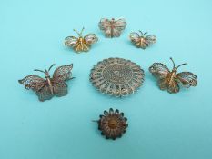 Three white metal gilt filigree brooches in the form of butterflies,