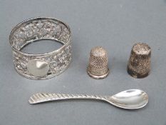 A hallmarked silver napkin ring, two silver thimbles and a salt spoon,