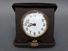 A 1910 eight day travel timepiece, in original case, the 60mm Arabic dial with luminous hands,