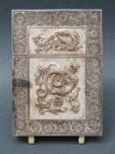 A white metal Chinese or Indian filigree card case decorated with snakes amongst flowers with a