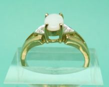 A 9ct gold ring set with an opal and diamonds,