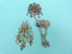 A white metal filigree brooch in a flower design,