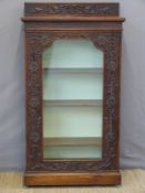 A late 19thC glazed carved mahogany bookcase,