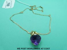 An 18ct gold pendant set with a heart cut amethyst and a diamond on a 9ct gold chain