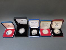 Five cased silver Royal commemorative crowns,
