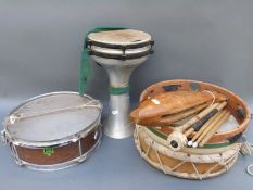 A collection of drums and other percussion instruments including a wooden fish
