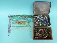 A collection of beads including lapis lazuli, glass,