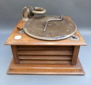 A vintage wind up gramophone in wooden cabinet with internal horn, nickel plated horn arm,