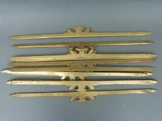 A set of 12 ornate brass stair rods,