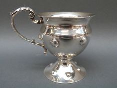 An Arts & Crafts or Art Nouveau hallmarked silver cup with gilt wash interior and embossed