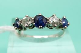 A white metal ring set with alternating diamonds and sapphires (Size M)