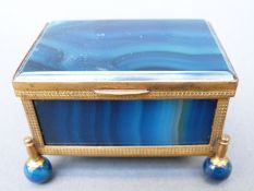 A blue banded agate and gilt metal mounted box raised on four ball feet,