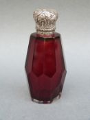 A white metal lidded red cut glass scent bottle, length 7.