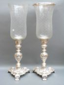 Two large silver plated and cut glass candle holders,