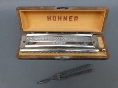 Hohner 64 Chromonica 4 chromatic octaves harmonica by Hohner and a tuning fork in key of C