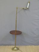 A brass library lamp with tray table and articulated arm,