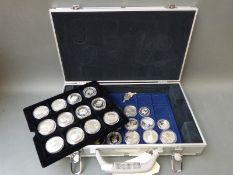 A metal coin collector's case containing thirty crown sized commemorative coins etc,