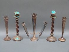 A hallmarked silver trumpet vase garniture comprising triple trumpet central vase and two single