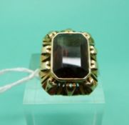 A yellow metal ring marked 585 set with a smoky quartz, weight 6.