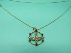 A 9ct gold Edwardian pendant and chain set with seed pearls and rubies in the form of a swallow.