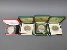 Four cased commemorative crowns