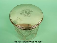 A Fabergé silver topped dressing table pot with ribbon decoration and banding around the top and