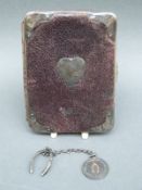 A hallmarked silver mounted purse together with a Most Cheery Order of Merrythoughts wishbone charm